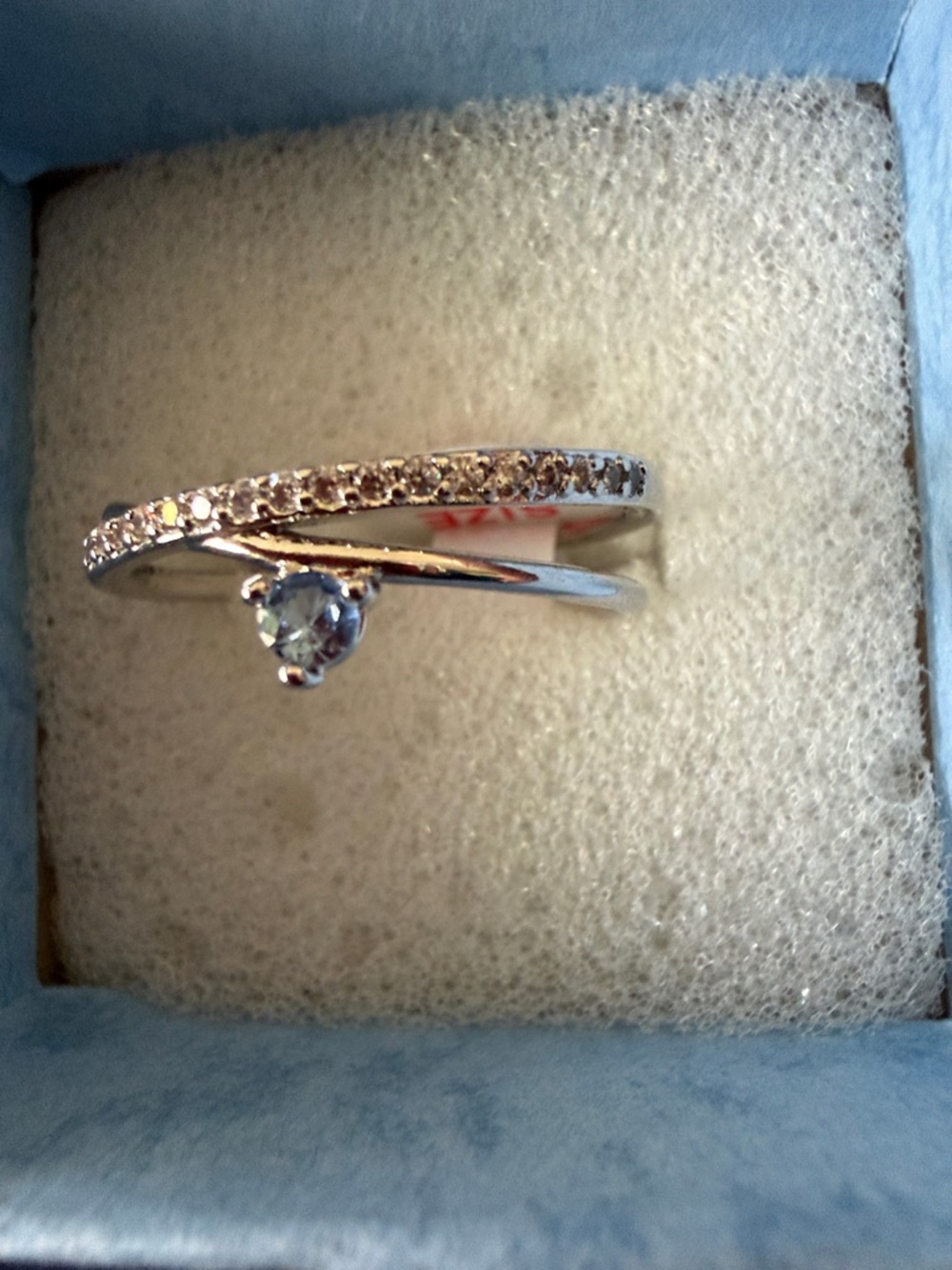 Crossing Paths Rhodium Plated Ring with Light Sapphire Blue Cubic Zirconia